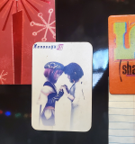 A rectangular magnet featuring a 3D rendering of MOMO and Sakura holding hands.